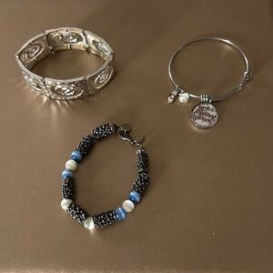 Three bracelets , 2 silver , 1 premier jewelry blue and white and silver